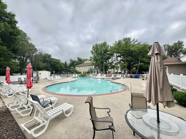 a backyard of a house with table and chairs