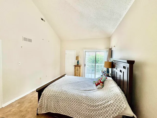 a bed room with a bed and a large window