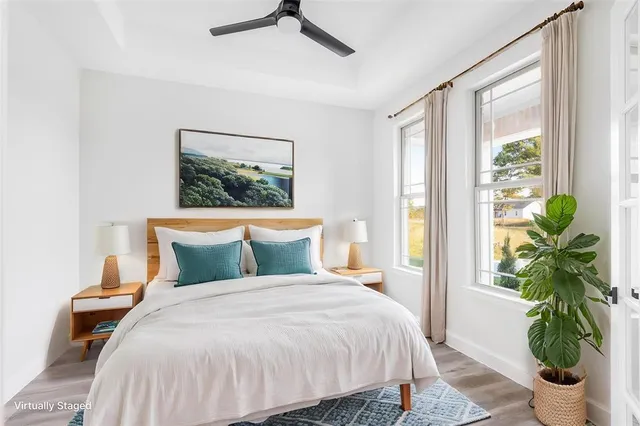 a bedroom with a bed and a potted plant