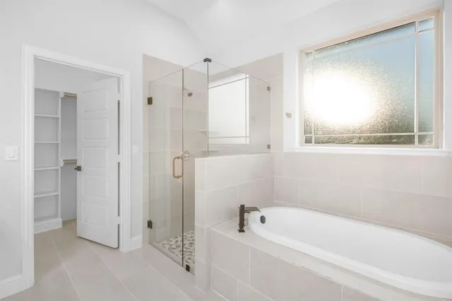 a bathroom with a bathtub and a shower