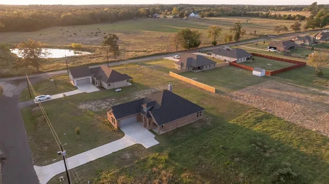an aerial view of a house with lake view