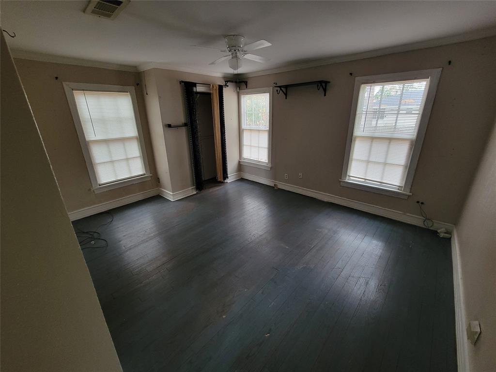 211 Wichita Street Shreveport, LA 71101 - Photo 7 of 10 Unfurnished bedroom with crown molding, a ceiling fan, and dark wood finished floors