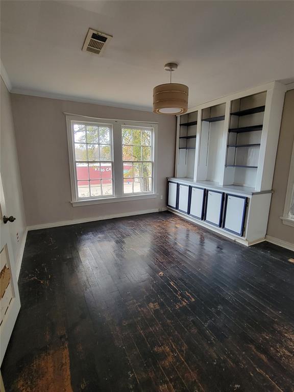 211 Wichita Street Shreveport, LA 71101 - Photo 9 of 10 Unfurnished living room with dark wood-style flooring and crown molding