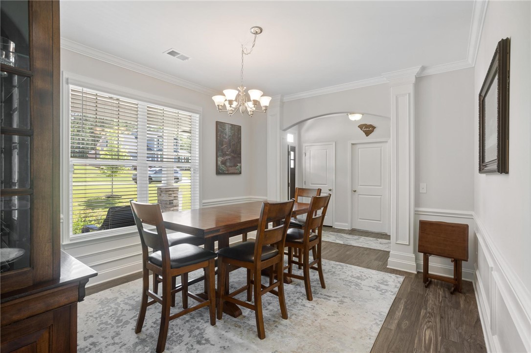 125 Estateside Drive Anderson, SC 29621 - Photo 10 of 37 Elegant dining space, perfect for gatherings, with hardwood flooring and crown molding.