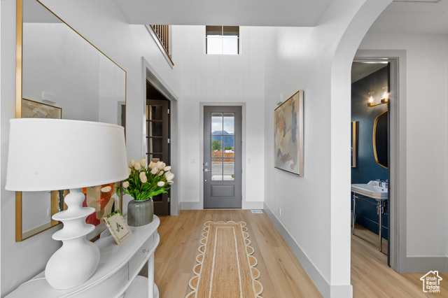 1447 North 1350 E Street, Unit 5 Mapleton, UT 84664 - Photo 6 of 10 Doorway with plenty of natural light, wood finished floors, a high ceiling, and arched walkways