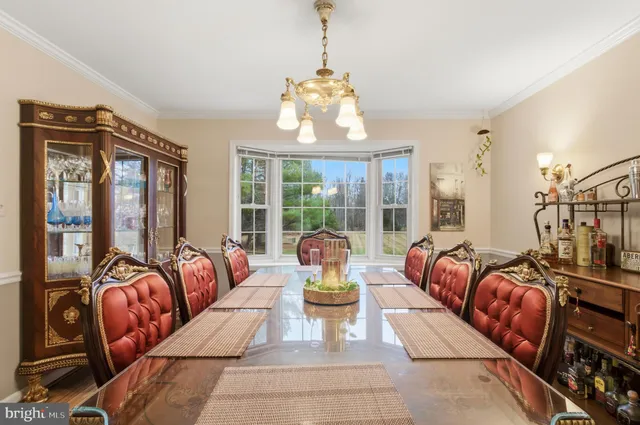 a dining room with furniture a chandelier and wooden floor
