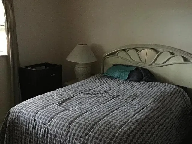 a bedroom with a bed and a window