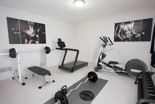 a kitchen with a refrigerator a stove top oven and cabinets