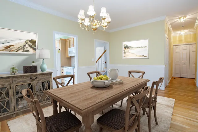 a view of a dining room with furniture and chandelier