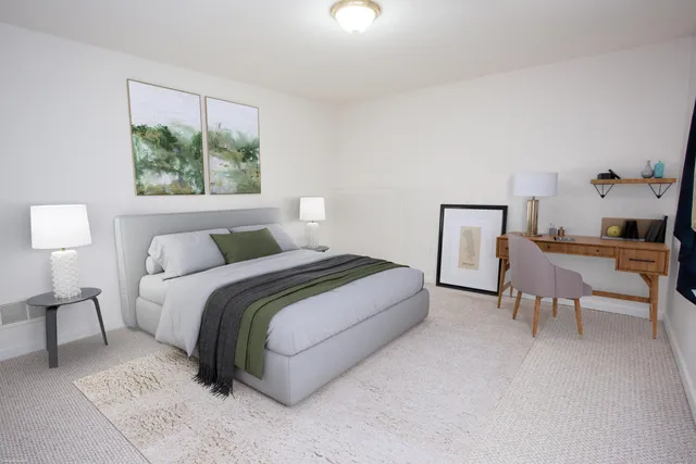 a bedroom with a bed and a window