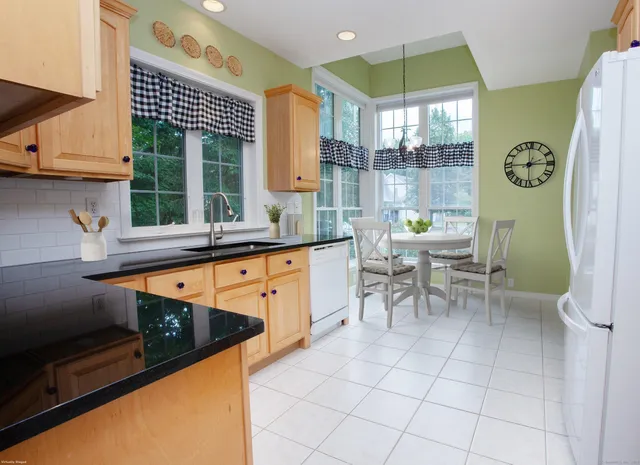 a kitchen with granite countertop a sink and a stove