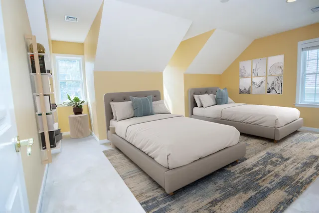 a bedroom with two beds and painted walls