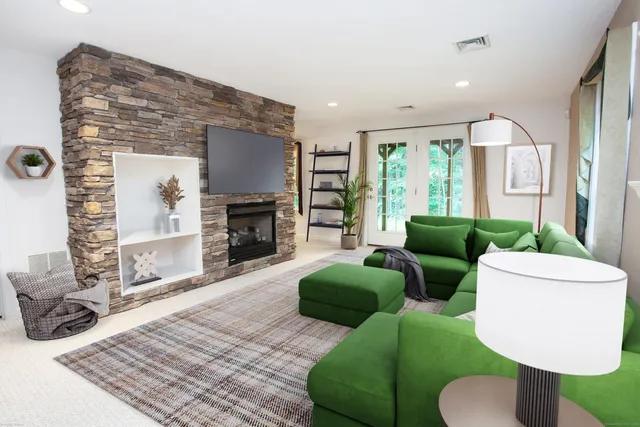 a living room with furniture and a fireplace