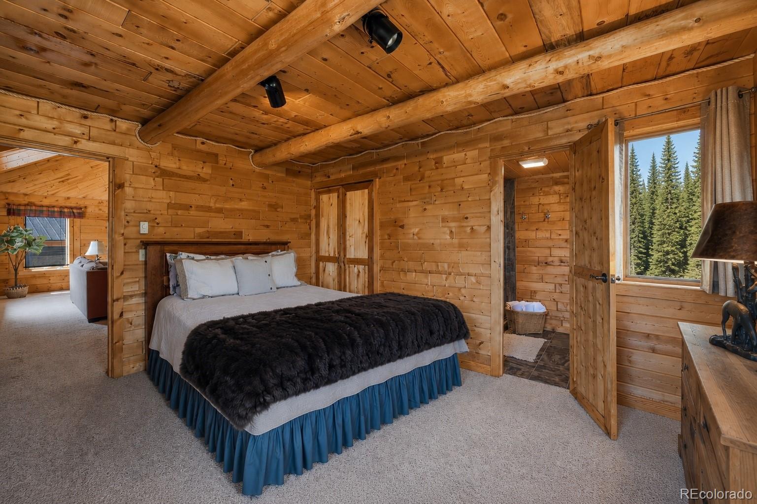 341 Anderson Road Walden, CO 80480 - Photo 37 of 50 a bedroom with a bed and large windows