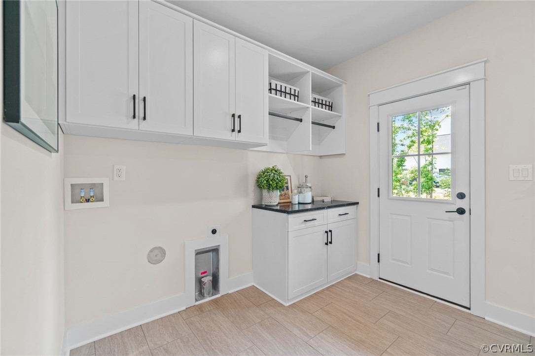 9440 Wickham Crossing Way Ashland, VA 23005 - Photo 20 of 26 a kitchen with white cabinets and wooden floor