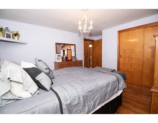 52 Hough Road Sutton, MA 01590 - Photo 15 of 23 a bedroom with a bed chandelier and a window