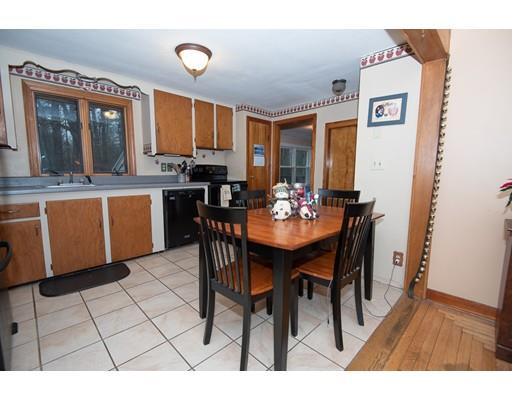 52 Hough Road Sutton, MA 01590 - Photo 4 of 23 a open dining room with stainless steel appliances a wooden table and chairs