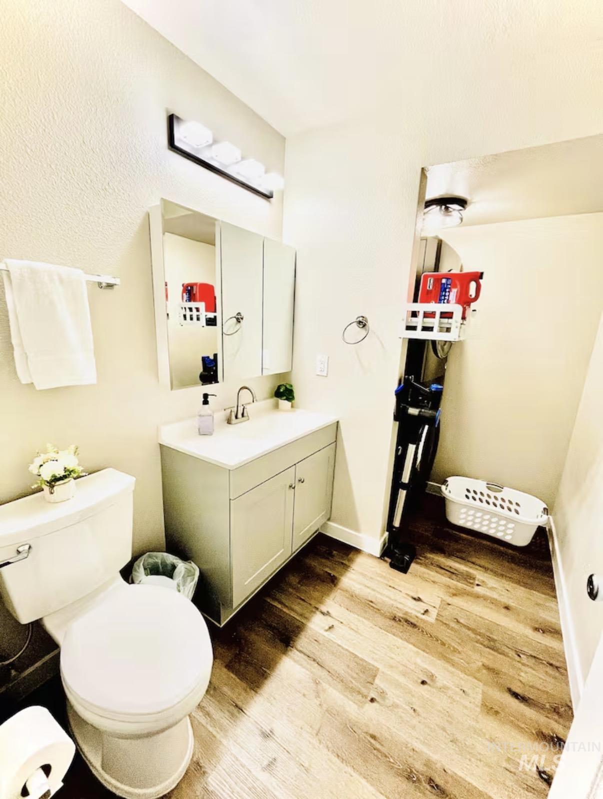 4802-4804 Maid Jessica Street Caldwell, ID 83607 - Photo 22 of 31 Bathroom with vanity, light wood-style floors, and a textured ceiling