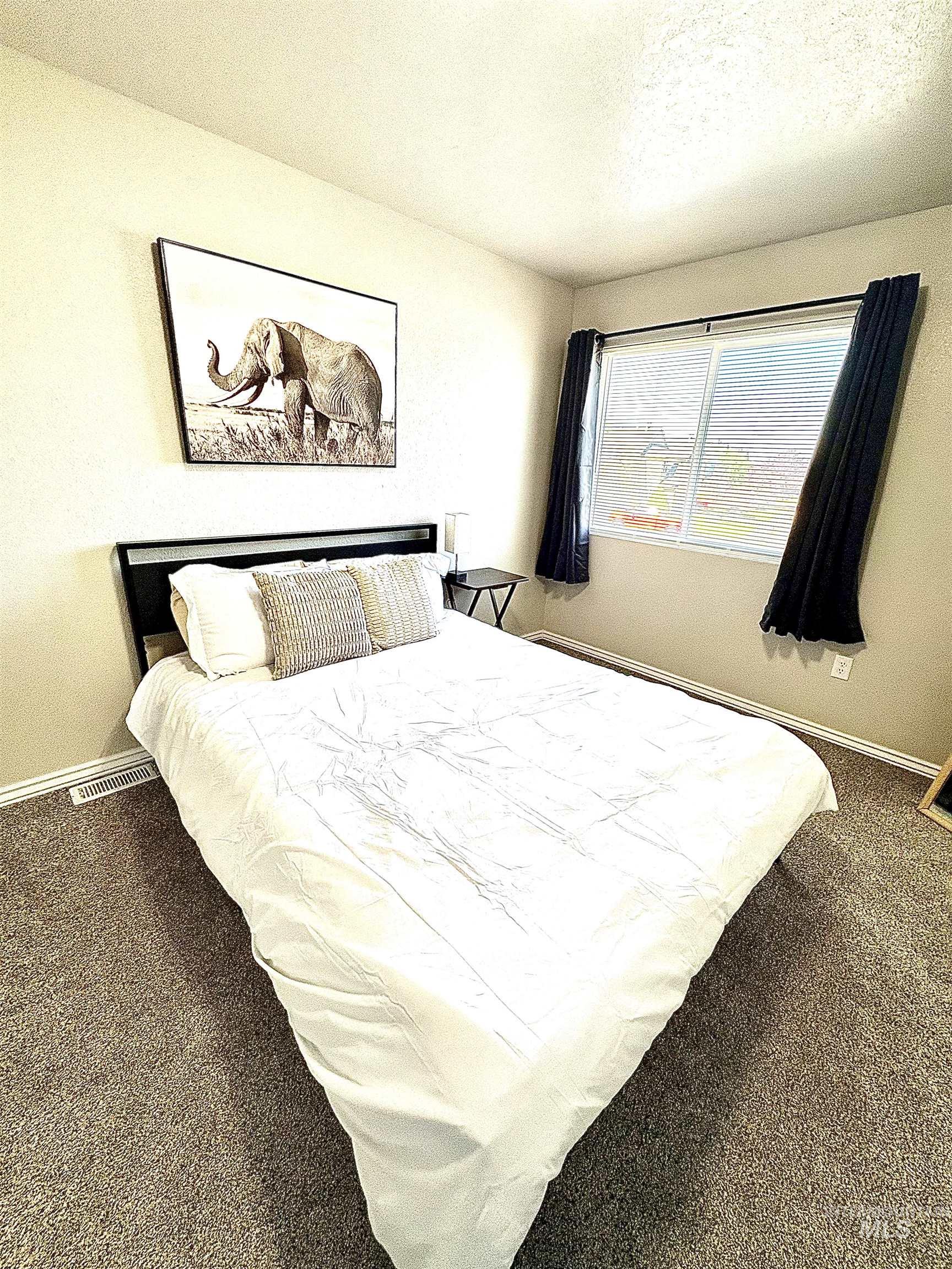 4802-4804 Maid Jessica Street Caldwell, ID 83607 - Photo 30 of 31 Bedroom featuring dark carpet and a textured ceiling