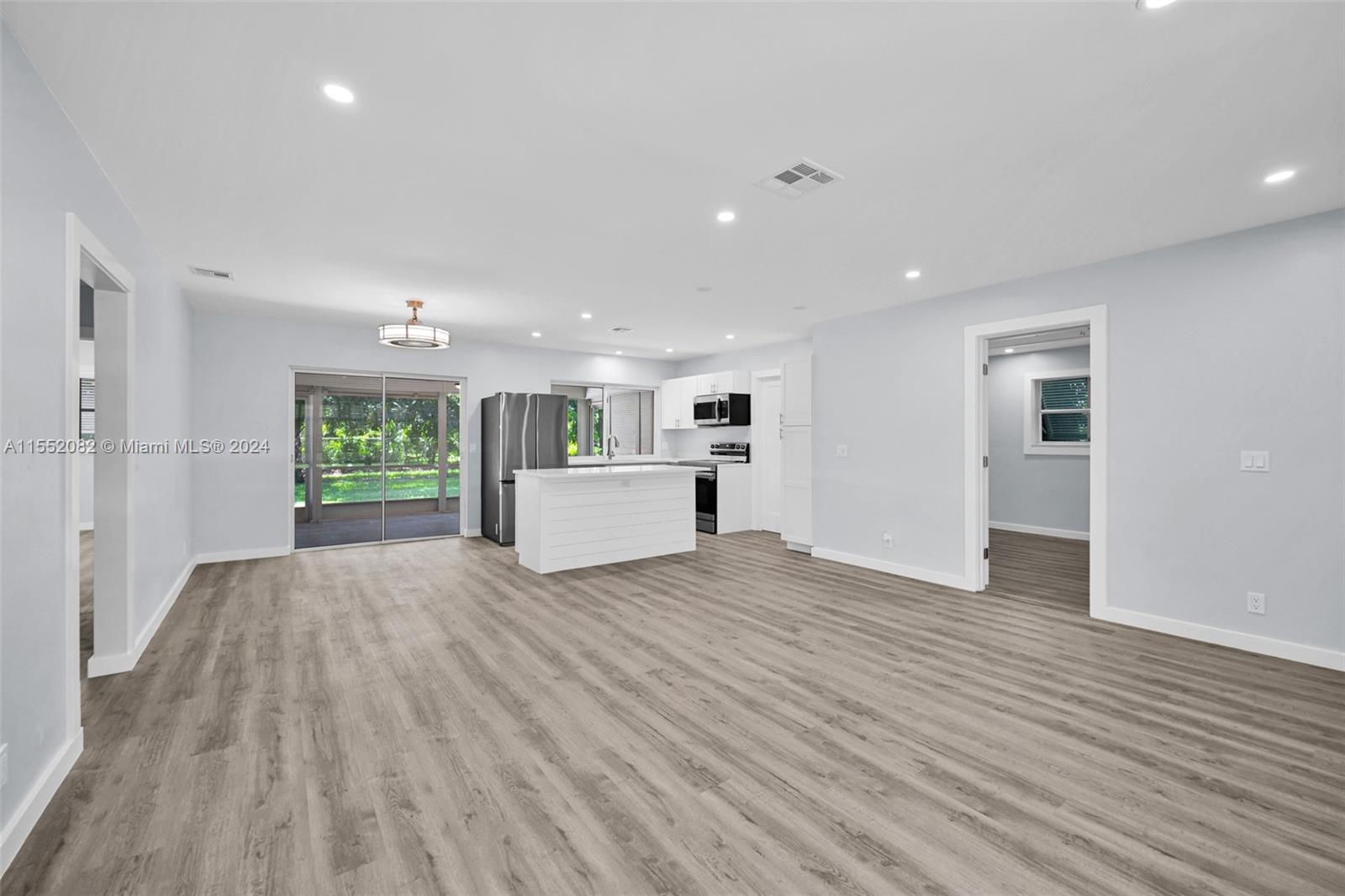 2598 Lone Pine Road Palm Beach Gardens, FL 33410 - Photo 11 of 29 a view of kitchen and wooden floor