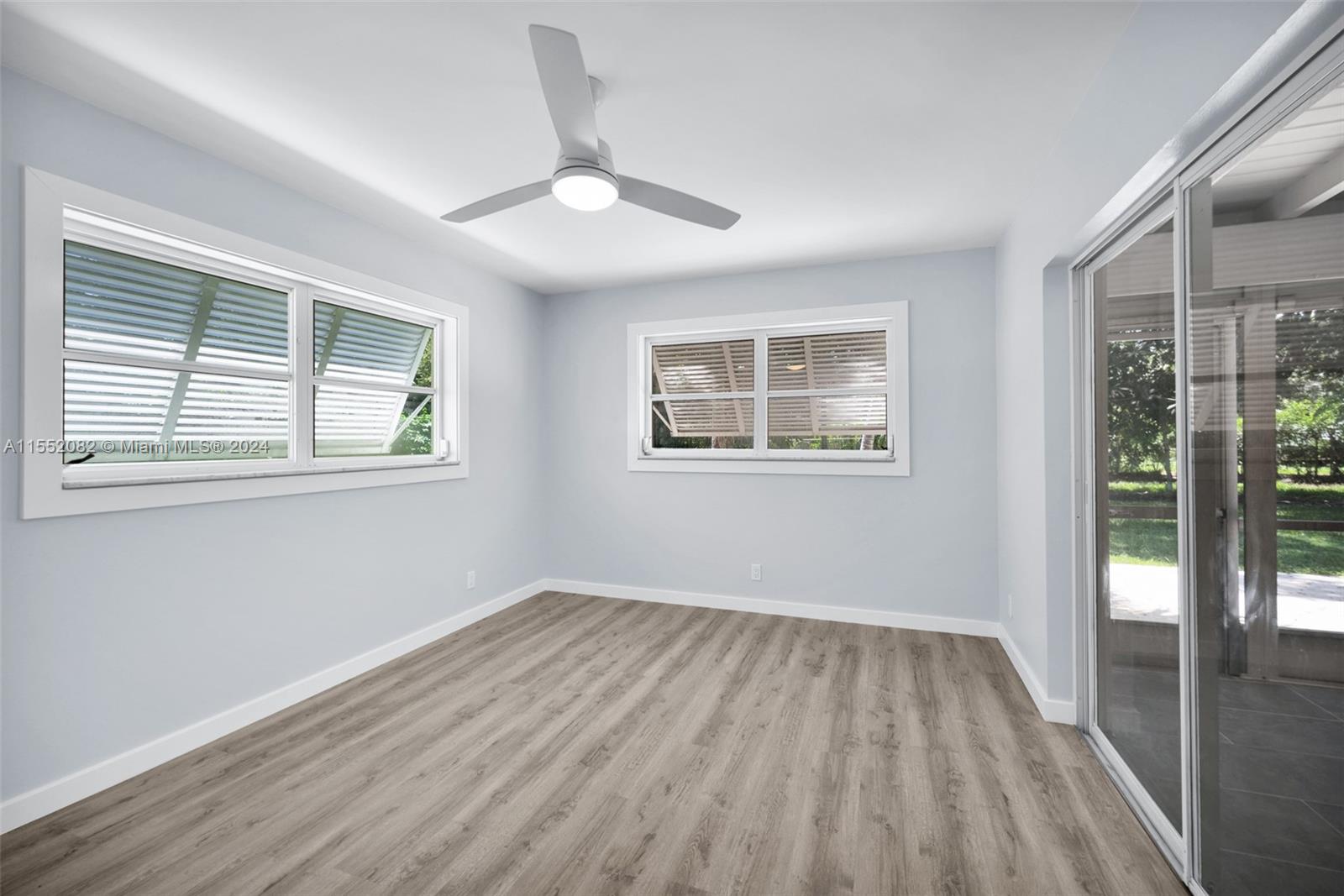 2598 Lone Pine Road Palm Beach Gardens, FL 33410 - Photo 14 of 29 a view of empty room with wooden floor and fan