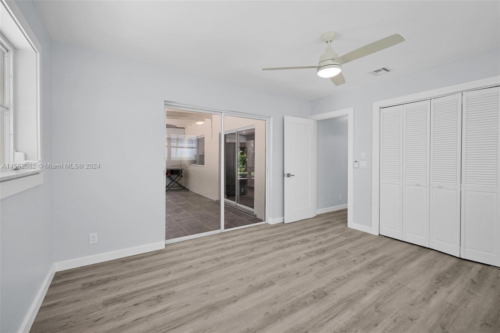 2598 Lone Pine Road Palm Beach Gardens, FL 33410 - Photo 16 of 29 a view of an empty room with wooden floor