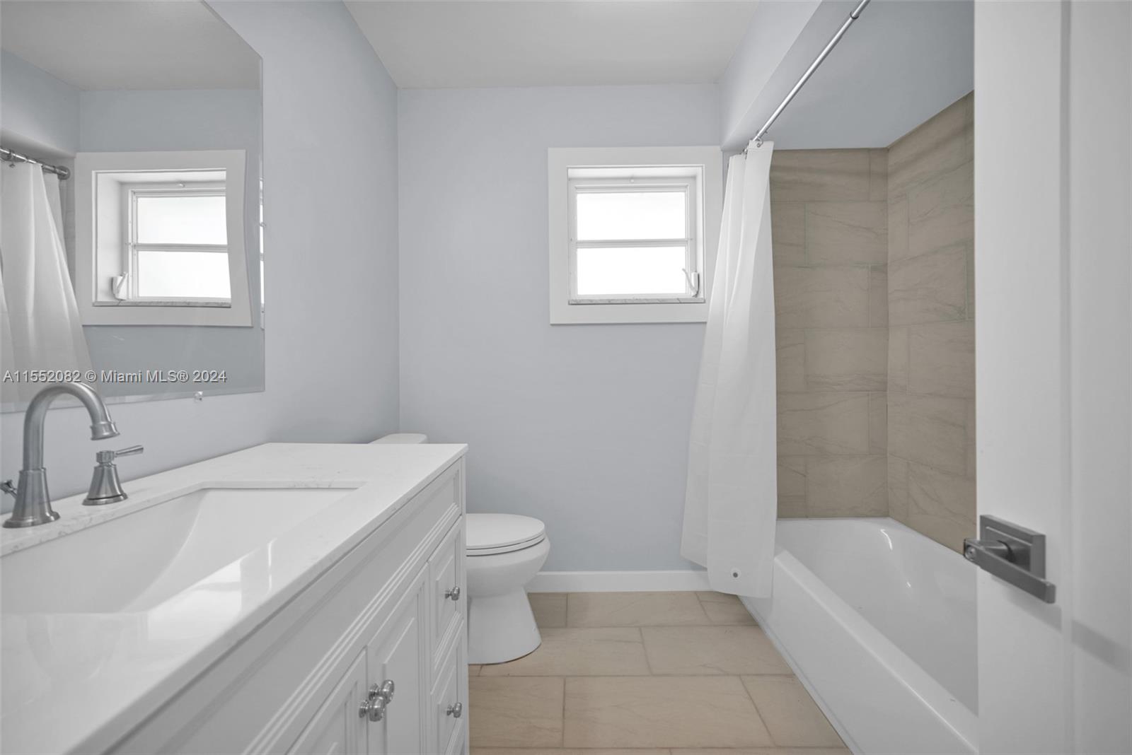 2598 Lone Pine Road Palm Beach Gardens, FL 33410 - Photo 17 of 29 a bathroom with a sink toilet vanity and bathtub