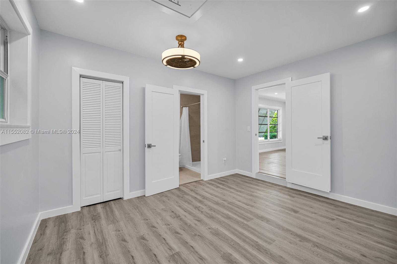 2598 Lone Pine Road Palm Beach Gardens, FL 33410 - Photo 18 of 29 wooden floor in an empty room with a window