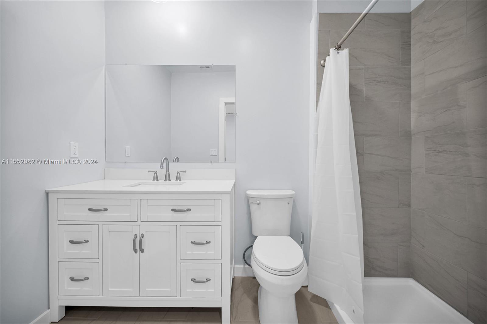 2598 Lone Pine Road Palm Beach Gardens, FL 33410 - Photo 20 of 29 a bathroom with a sink a toilet and vanity