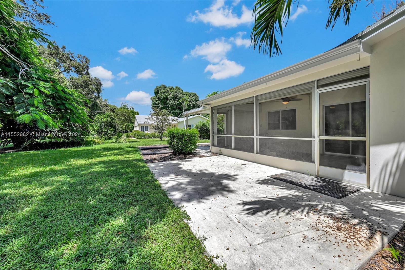 2598 Lone Pine Road Palm Beach Gardens, FL 33410 - Photo 2 of 29 a view of a backyard with a garden and plants