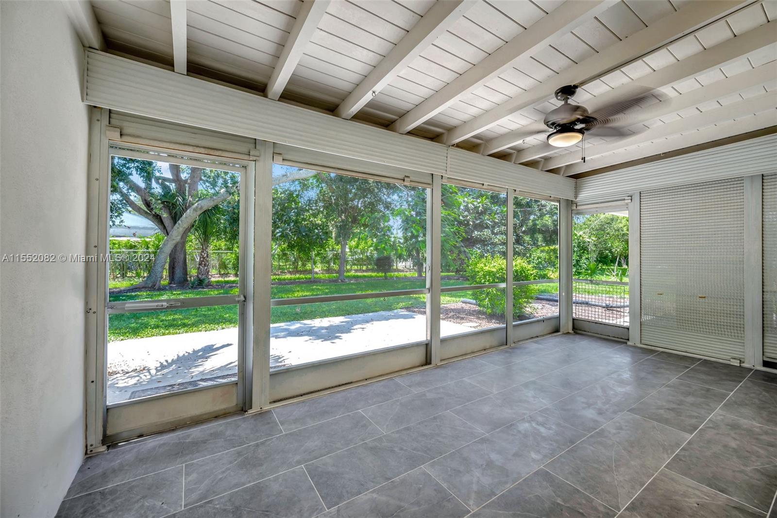 2598 Lone Pine Road Palm Beach Gardens, FL 33410 - Photo 24 of 29 a view of an empty room with windows and ceiling fan