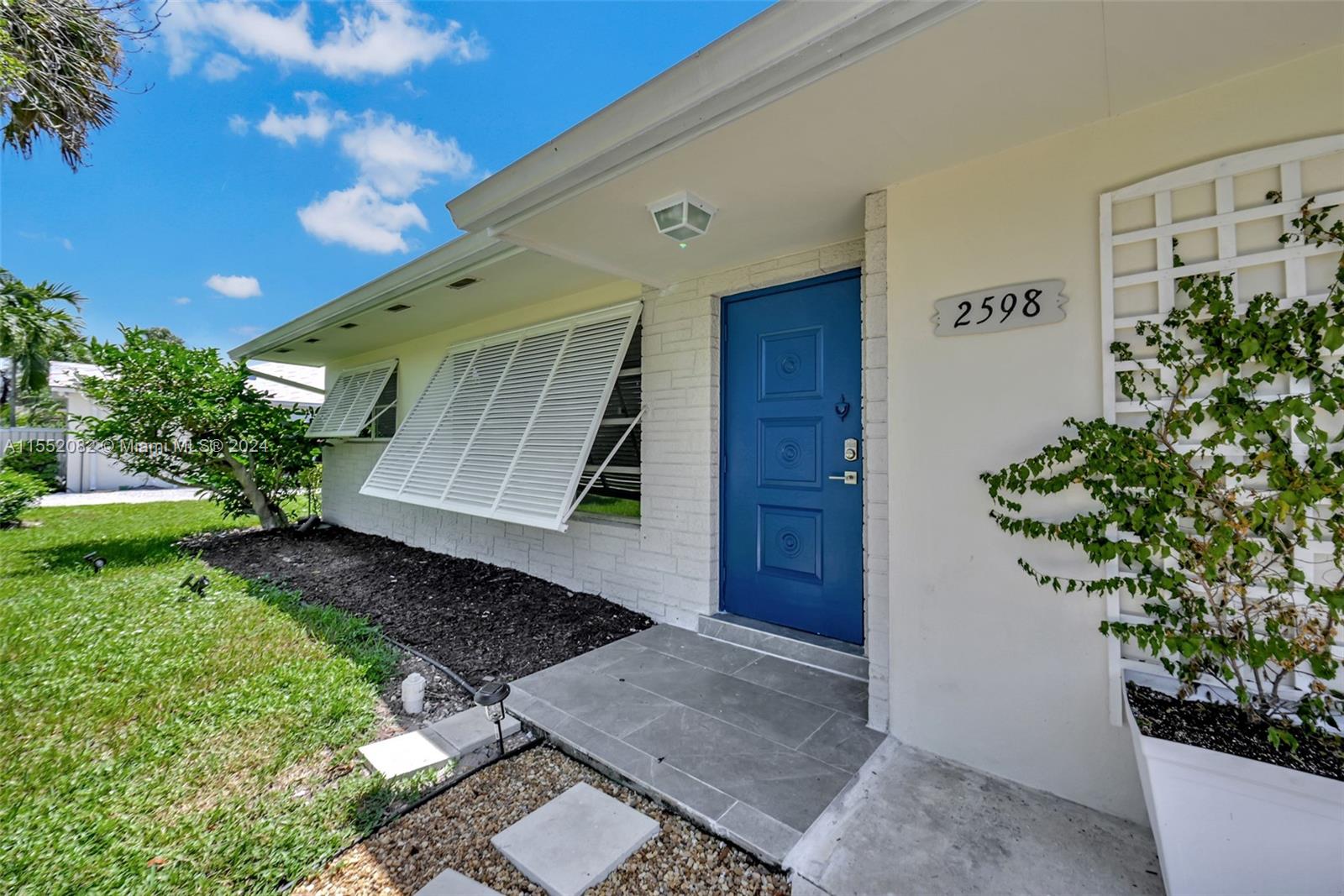 2598 Lone Pine Road Palm Beach Gardens, FL 33410 - Photo 28 of 29 a front view of a house with garden