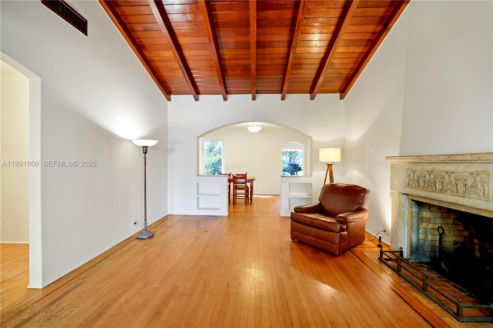 720 Northeast 75th Street Miami, FL 33138 - Photo 1 of 36 a living room with furniture and a fireplace