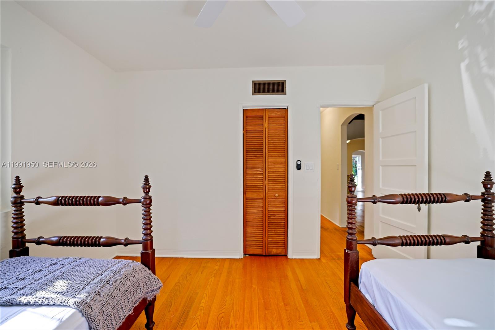 720 Northeast 75th Street Miami, FL 33138 - Photo 12 of 36 a bedroom with a bed and wooden floor