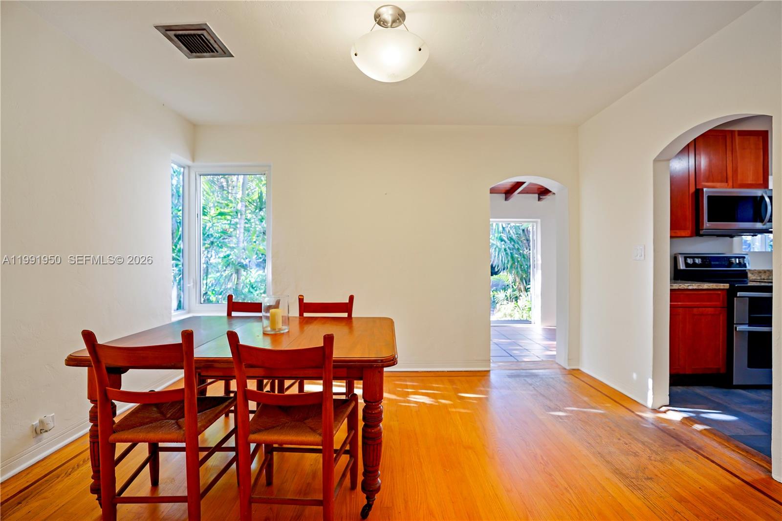 720 Northeast 75th Street Miami, FL 33138 - Photo 13 of 36 a view of a dining room with furniture and wooden floor