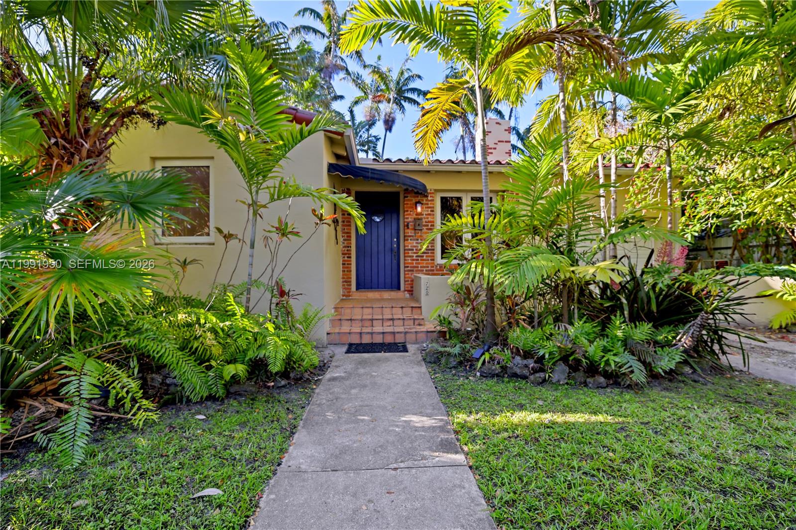 720 Northeast 75th Street Miami, FL 33138 - Photo 18 of 36 a front view of a house with garden