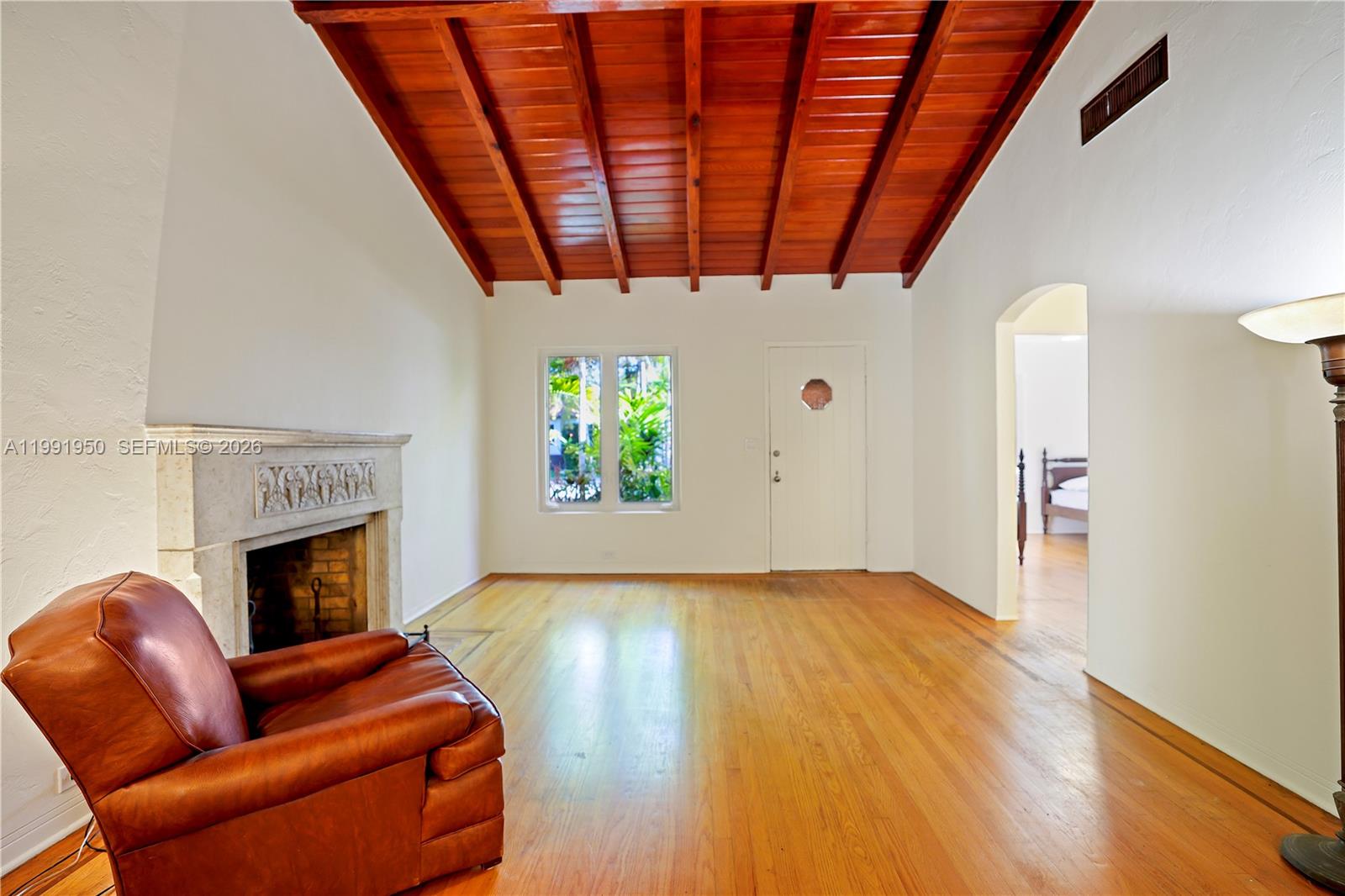720 Northeast 75th Street Miami, FL 33138 - Photo 20 of 36 a living room with furniture and a fireplace
