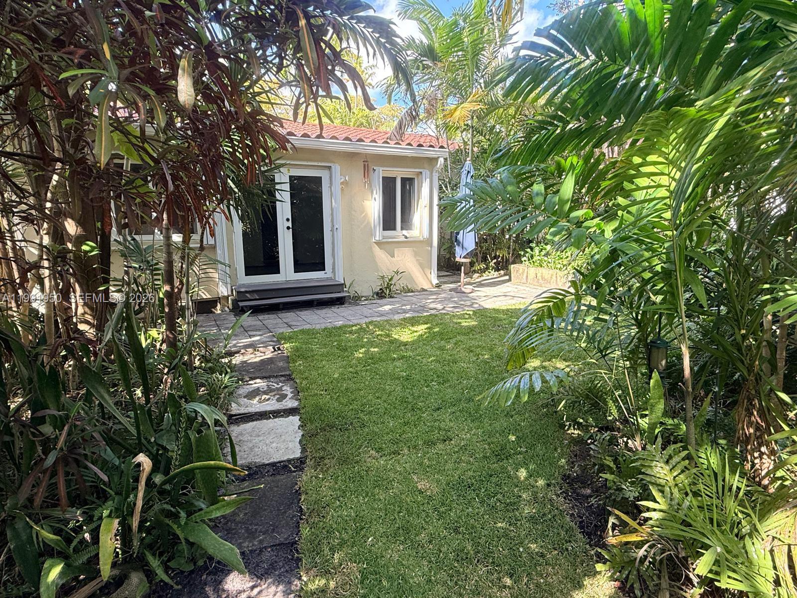 720 Northeast 75th Street Miami, FL 33138 - Photo 26 of 36 front view of a house with a yard