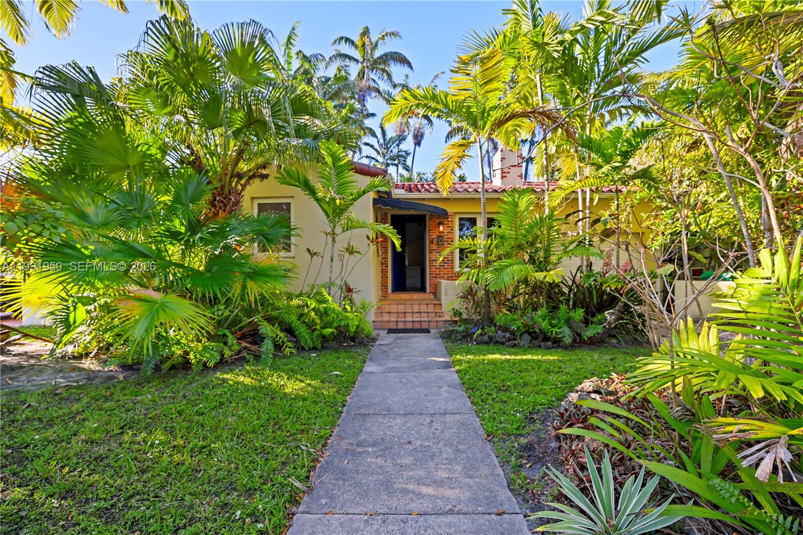 720 Northeast 75th Street Miami, FL 33138 - Photo 3 of 36 a front view of a house with garden