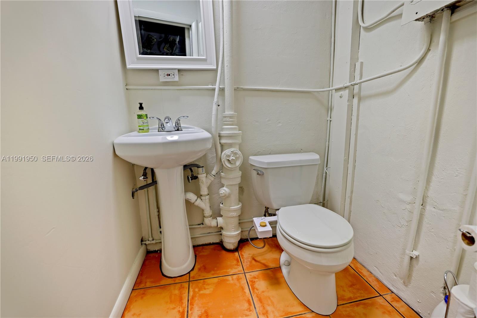 720 Northeast 75th Street Miami, FL 33138 - Photo 32 of 36 a bathroom with a toilet and a sink