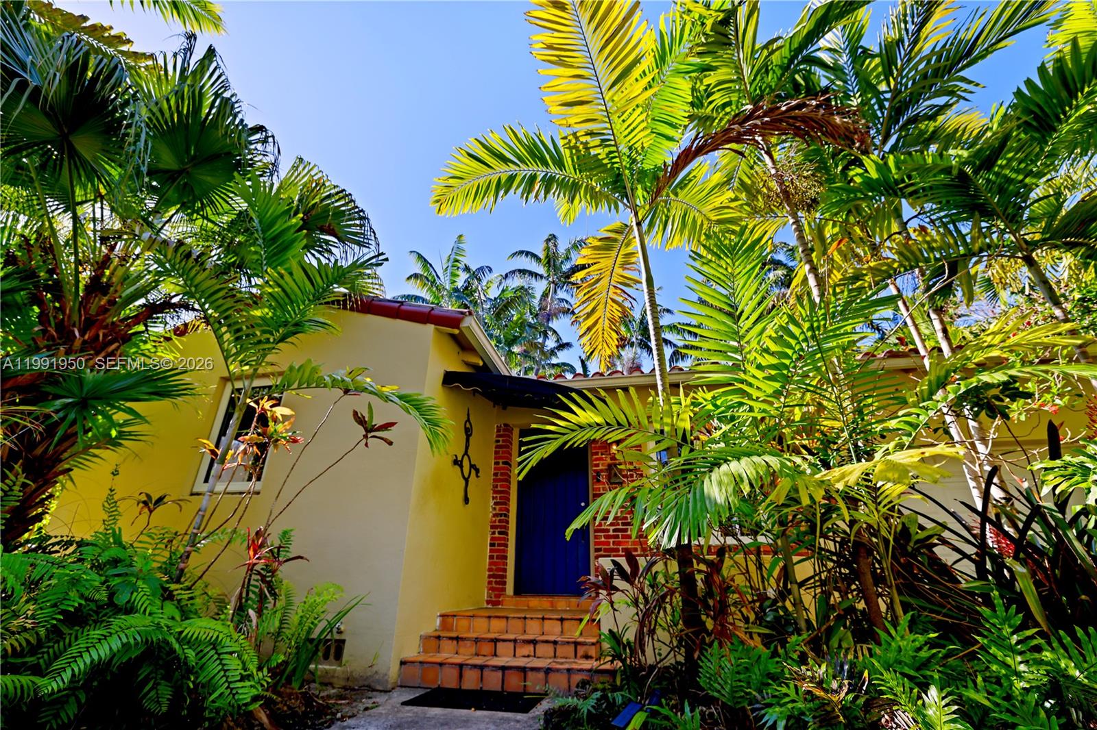 720 Northeast 75th Street Miami, FL 33138 - Photo 35 of 36 a view of a house with a flower garden