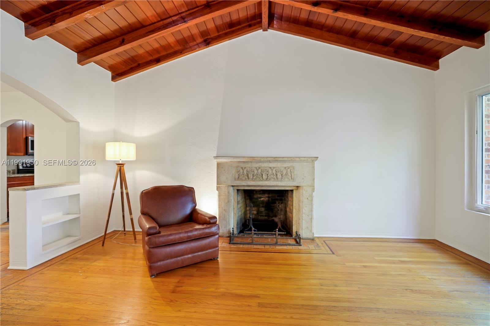 720 Northeast 75th Street Miami, FL 33138 - Photo 6 of 36 a living room with furniture and a fireplace