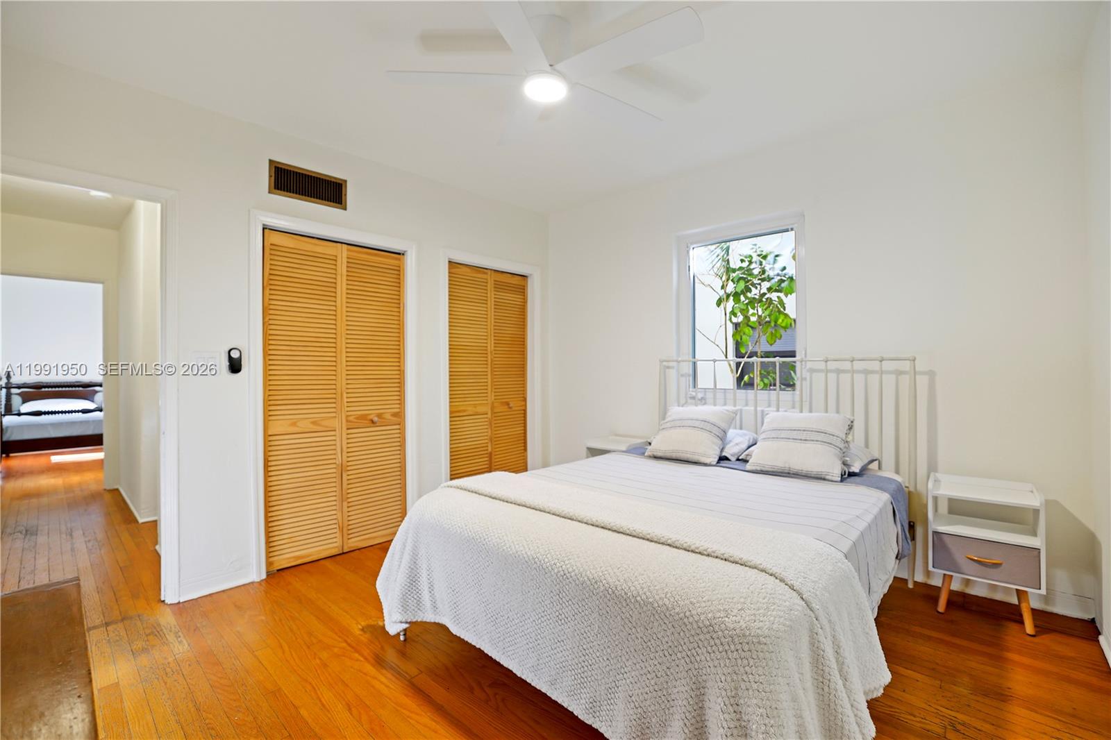720 Northeast 75th Street Miami, FL 33138 - Photo 8 of 36 a bedroom with a bed and a table