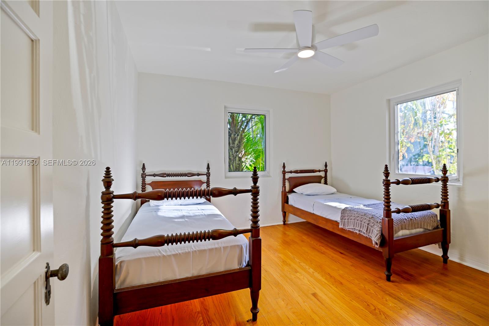 720 Northeast 75th Street Miami, FL 33138 - Photo 9 of 36 a bedroom with a bed and a dresser