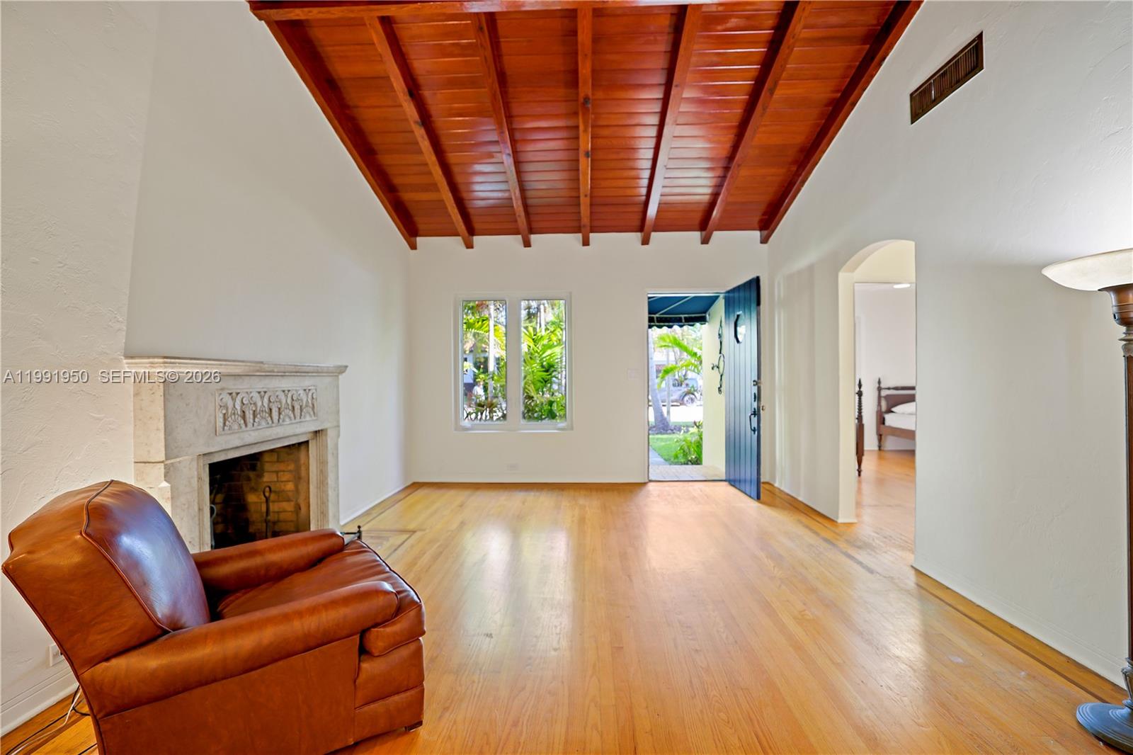 720 Northeast 75th Street Miami, FL 33138 - Photo 10 of 36 a view of livingroom with furniture a fireplace and wooden floor