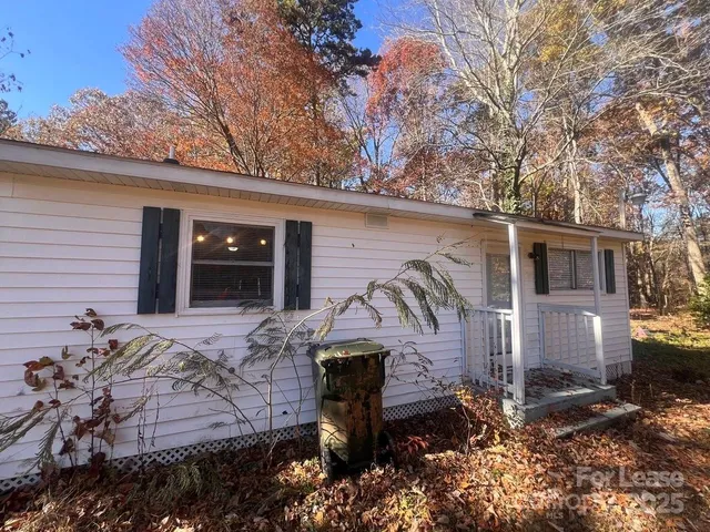 a view of a backyard with large trees