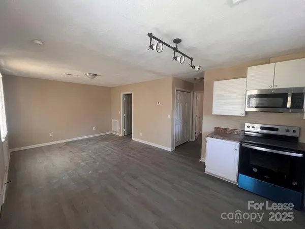 a kitchen with stainless steel appliances granite countertop a stove and a refrigerator