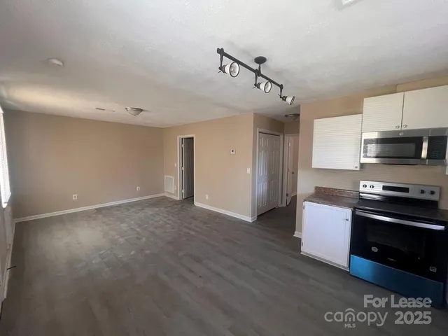 a kitchen with stainless steel appliances granite countertop a stove and a refrigerator
