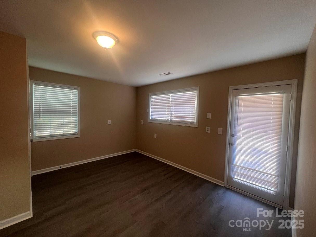 144 Mountain View Road, Unit B Bessemer City, NC 28016 - Photo 5 of 25 an empty room with wooden floor and windows