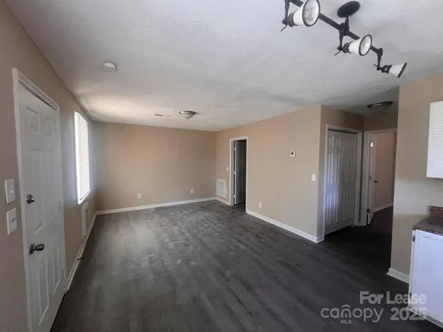 a view of a room with wooden floor and a window